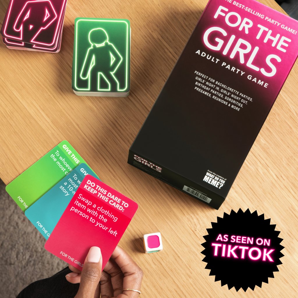 Board game box titled 'For the Girls' with cards and dice on a wooden surface, featuring TikTok branding.