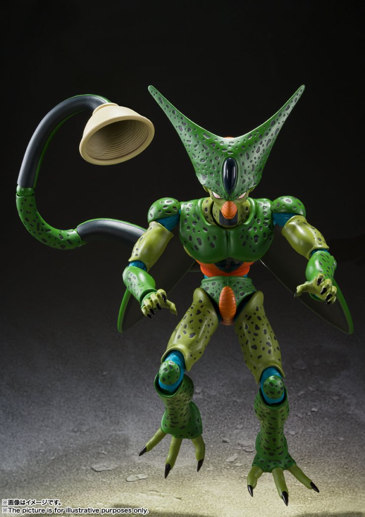 Toy figure of a green alien character with a large head and long tail on a dark background