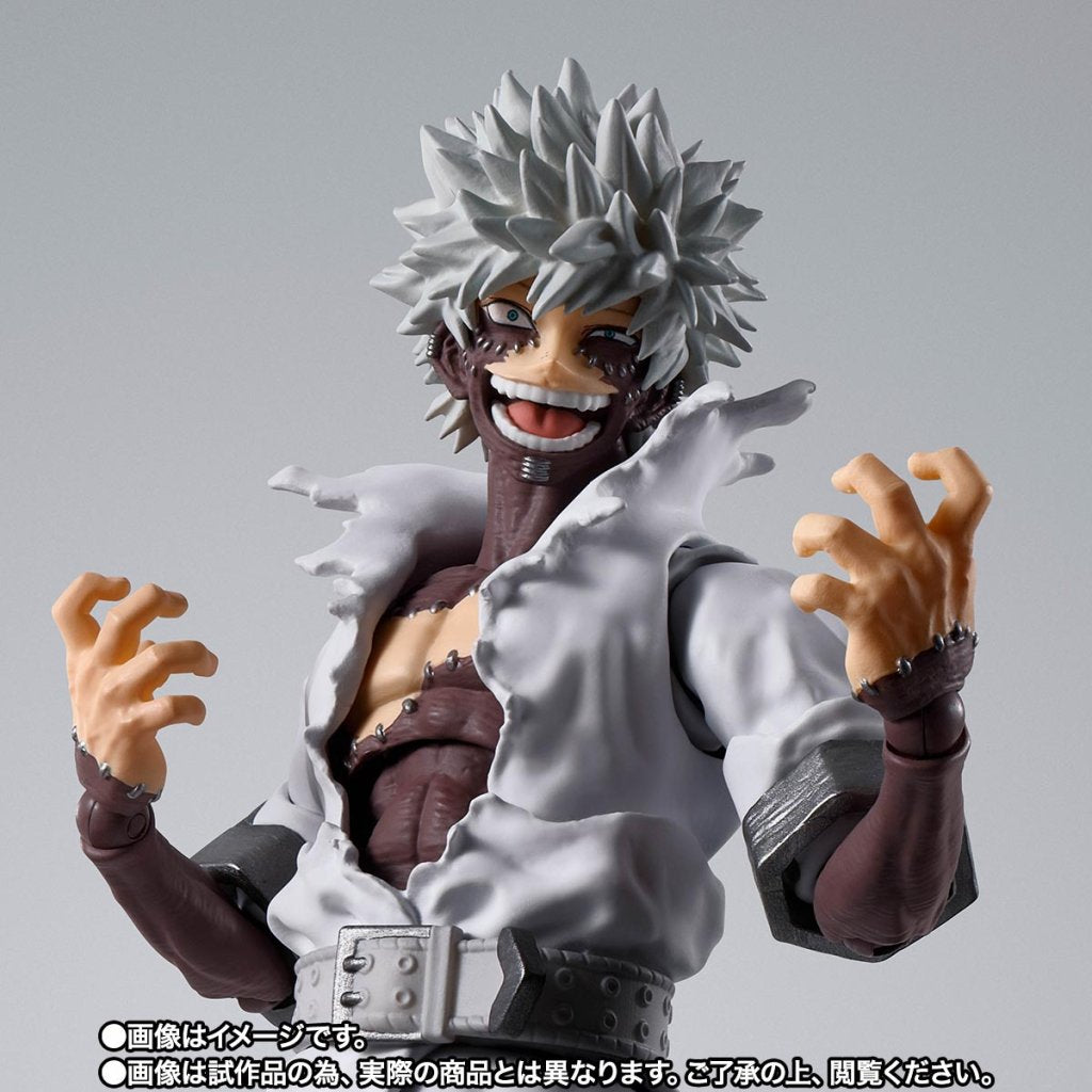 Action figure with spiky white hair and open shirt on a gray background