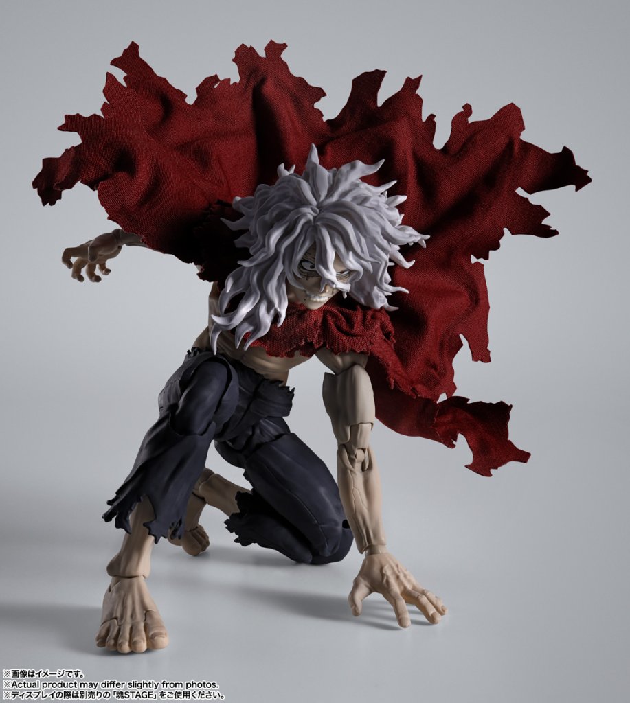 Action figure with red and black costume on a gray background