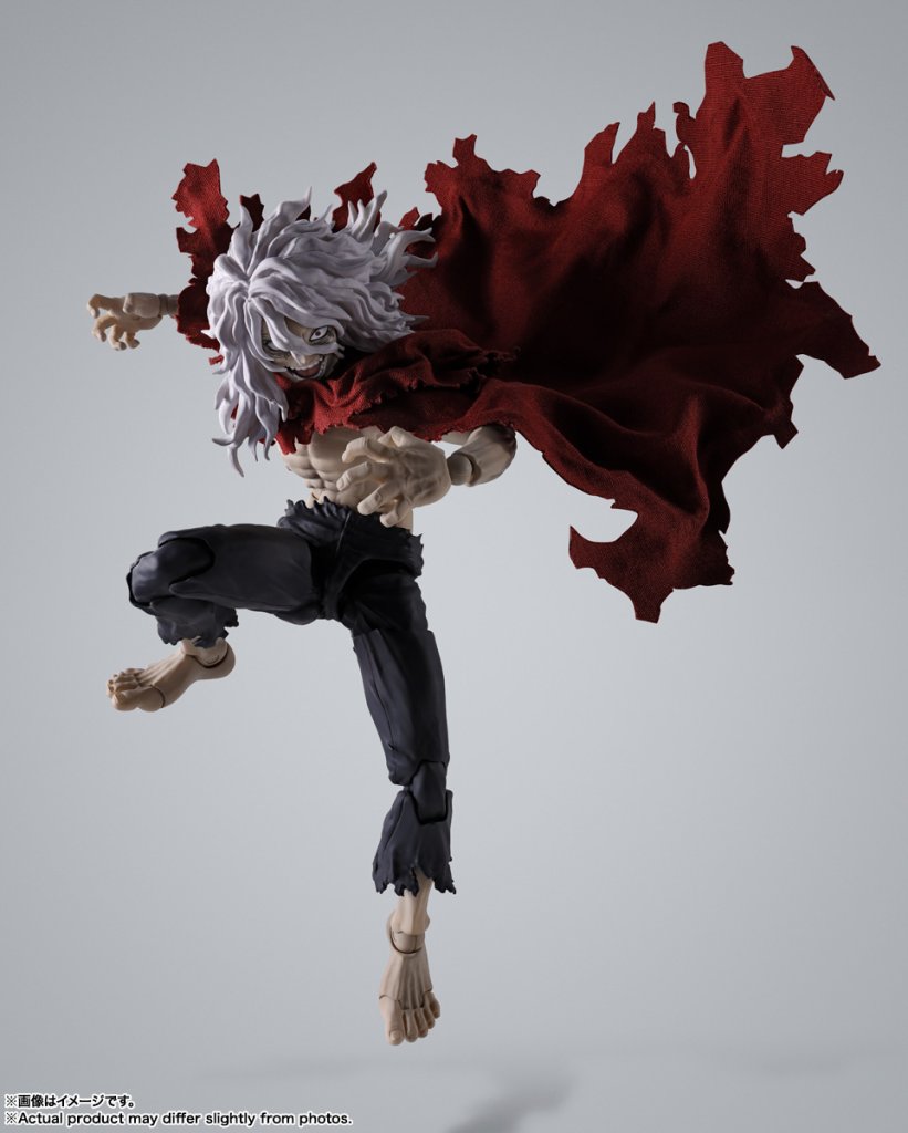 Action figure with a red and black outfit on a gray background